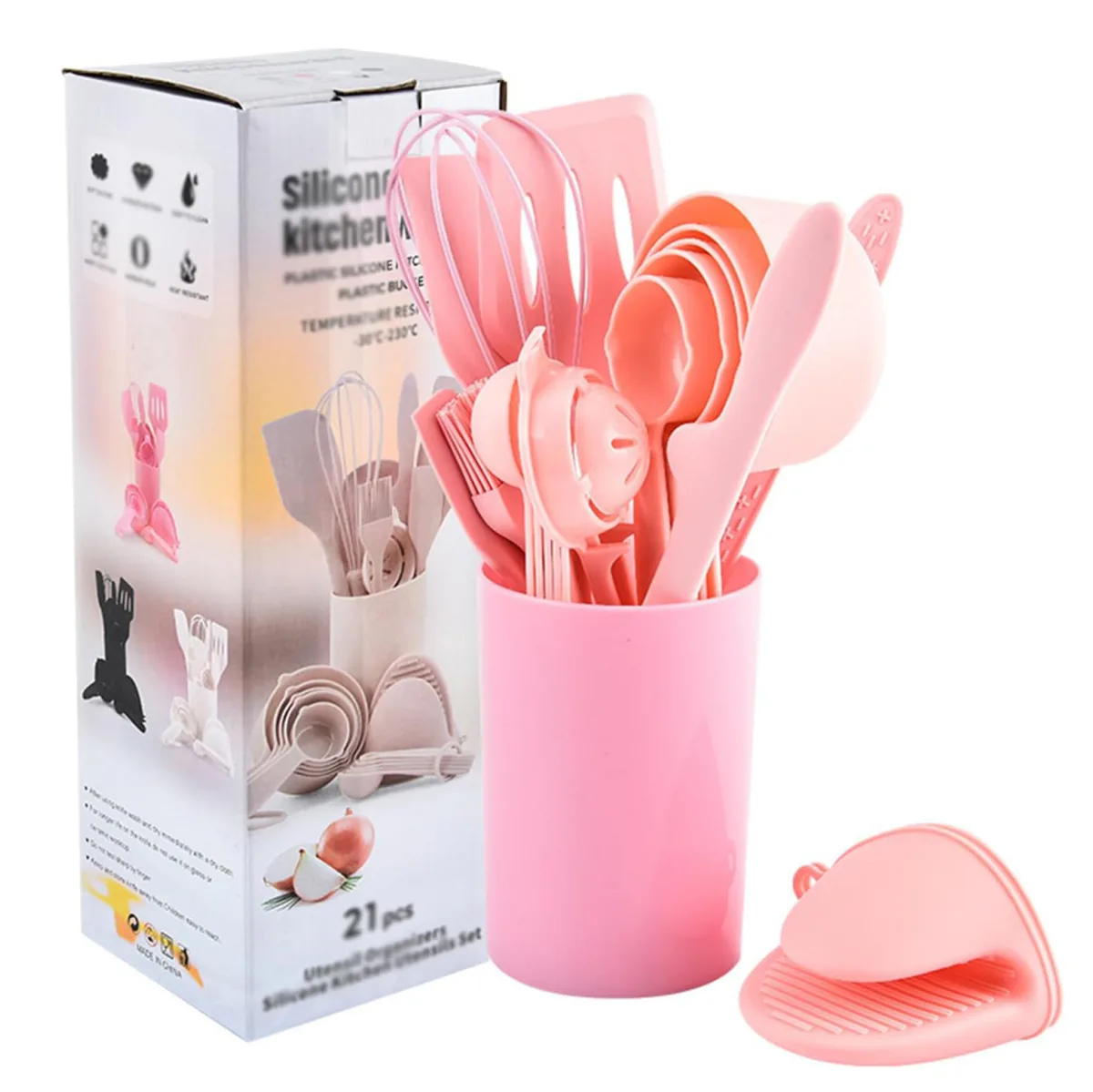Utensilios de cocina de silicona rosados en su vaso soporte junto a la caja